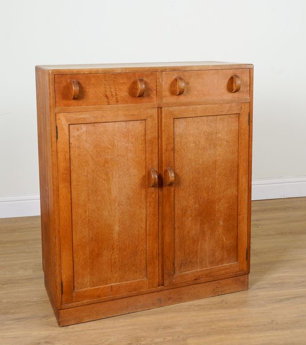 HEAL'S TOTTENHAM COURT ROAD, LONDON W1; A LIMED OAK SIDE CABINET WITH PAIR OF DRAWERS OVER CUPBOARDS