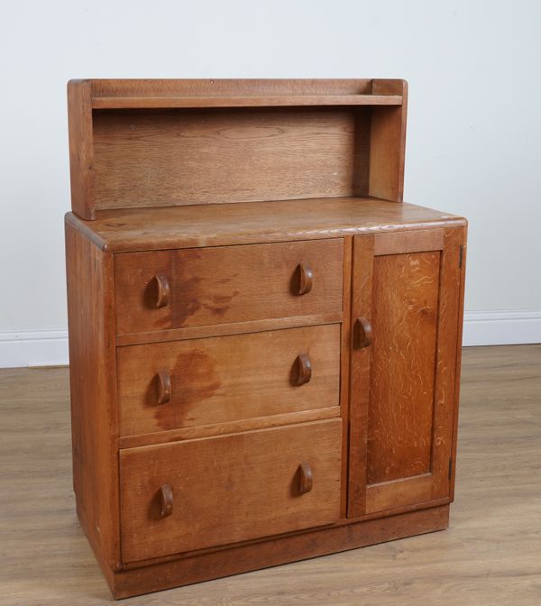 HEAL'S TOTTENHAM COURT ROAD, LONDON W1; A LIMED OAK SHELF BACK CABINET WITH THREE DRAWERS AND CUPBOARD