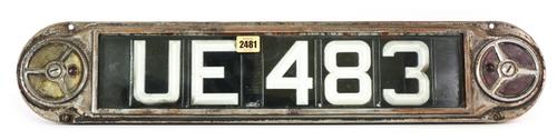 A MID 20TH CENTURY METAL FRAMED AUTOMOBILE NUMBER PLATE AND SURROUND