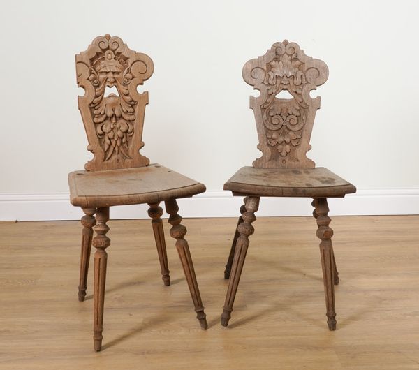 A PAIR OF 19TH CENTURY BLEACHED OAK GREEN MAN CARVED HALL CHAIRS (2)