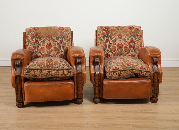 A PAIR OF EARLY 20TH CENTURY STUDED TAN LEATHER UPHOLSTERED CARVED OAK FRAMED EASY ARMCHAIRS (2)