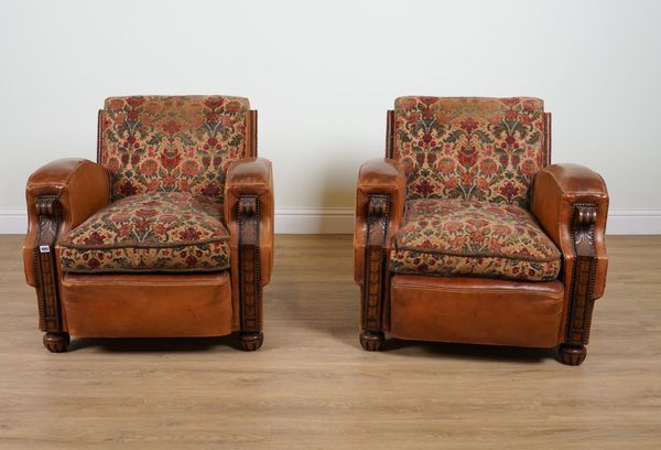 A PAIR OF EARLY 20TH CENTURY STUDED TAN LEATHER UPHOLSTERED CARVED OAK FRAMED EASY ARMCHAIRS (2)