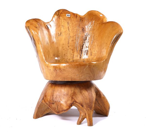 A NATURALISTIC CARVED HARDWOOD TUB BACK SWIVEL ARMCHAIR