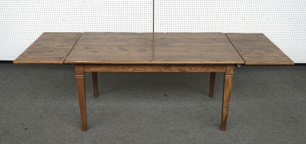 OKA; A FRENCH STYLE OAK EXTENDING DINING TABLE