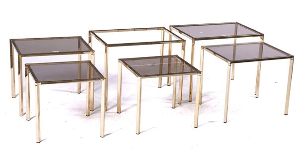 TWO NESTS OF THREE LACQUERED BEASS AND SMOKED GLASS OCCASIONAL TABLES  (6)