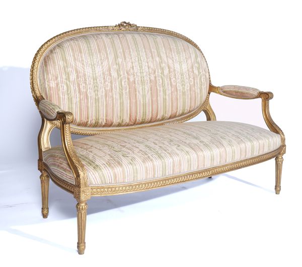 A LOUIS XVI STYLE GILT FRAMED OPEN ARM SETTEE