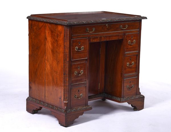 A GEORGE II MAHOGANY KNEEHOLE WRITING DESK