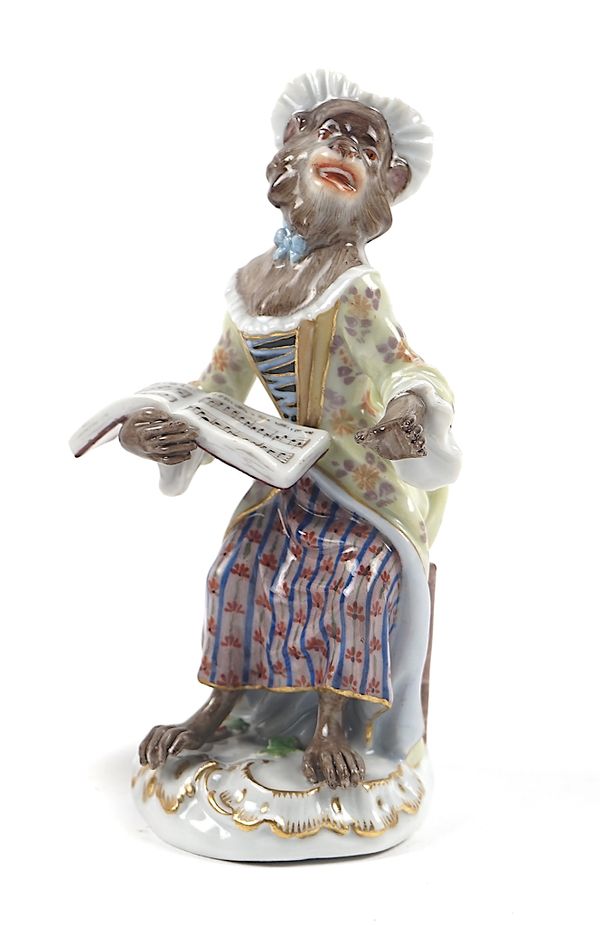 A MEISSEN MONKEY BAND SEATED FEMALE SINGER