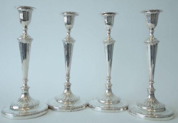 A GEORGE III SET OF FOUR SILVER TABLE CANDLESTICKS (4)