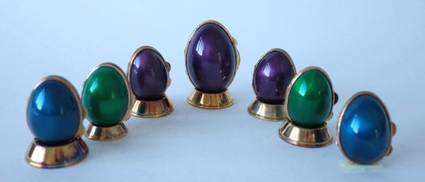 SEVEN ENAMELLED EGG SHAPED HINGE LIDDED BOXES (7)