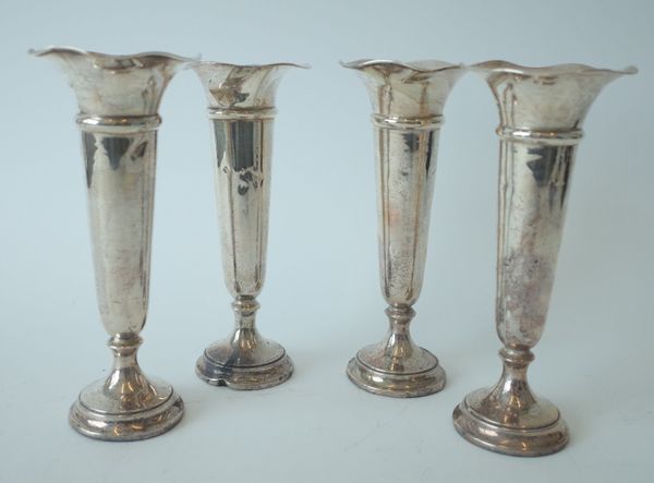 A SET OF FOUR SILVER TRUMPET SHAPED VASES (4)