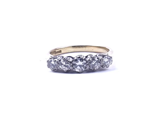 A GOLD AND DIAMOND FIVE STONE RING