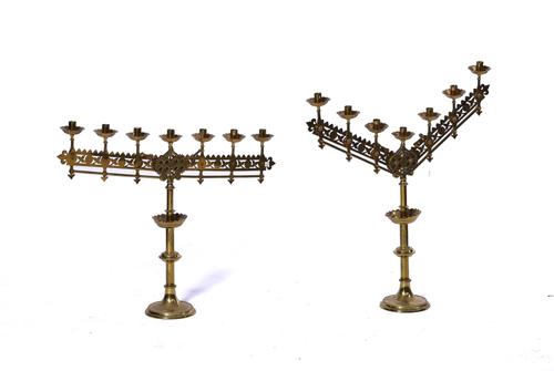 A PAIR OF GOTHIC REVIVAL POLISHED BRASS SEVEN-LIGHT CANDELABRA