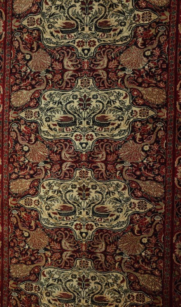 A BELUCHE RUG WITH FOUR SHAPED MEDALLIONS