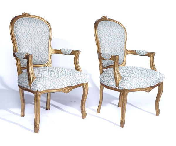 A PAIR OF LOUIS XV STYLE GILT FRAMED OPEN ARMCHAIRS