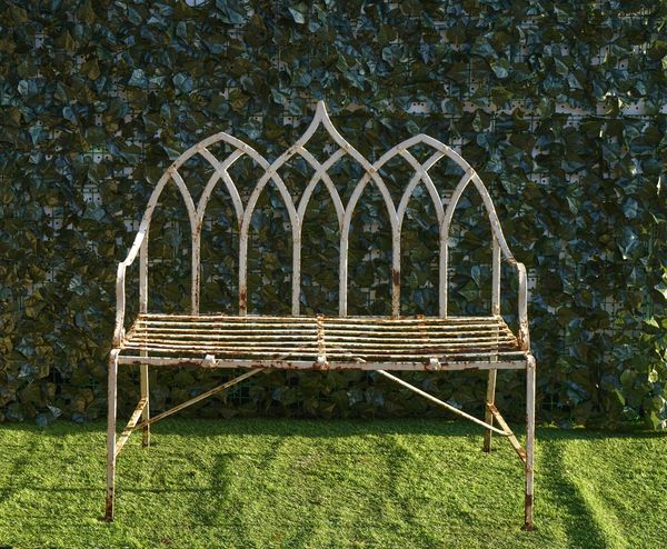 A LATE 19TH CENTURY REGENCY STYLE WHITE PAINTED STRAPWORK GARDEN BENCH