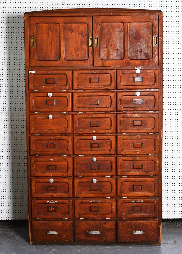 A 20TH CENTURY STAINED PINE LOCKER CABINET