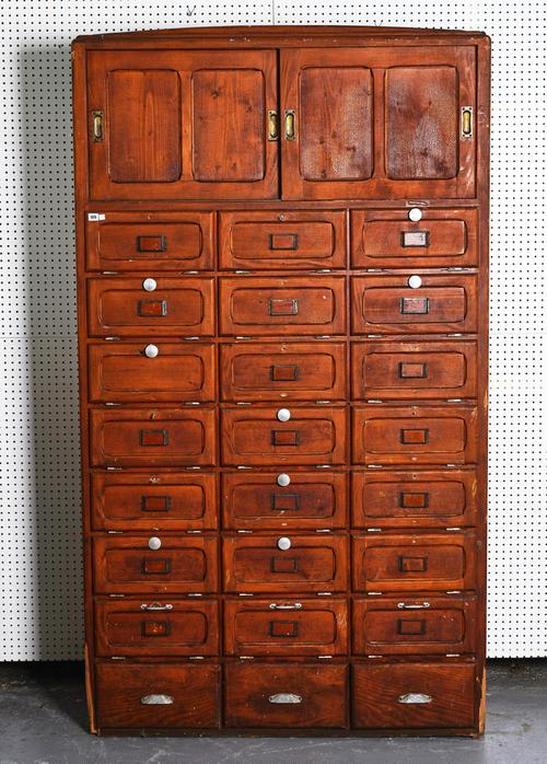 A 20TH CENTURY STAINED PINE LOCKER CABINET