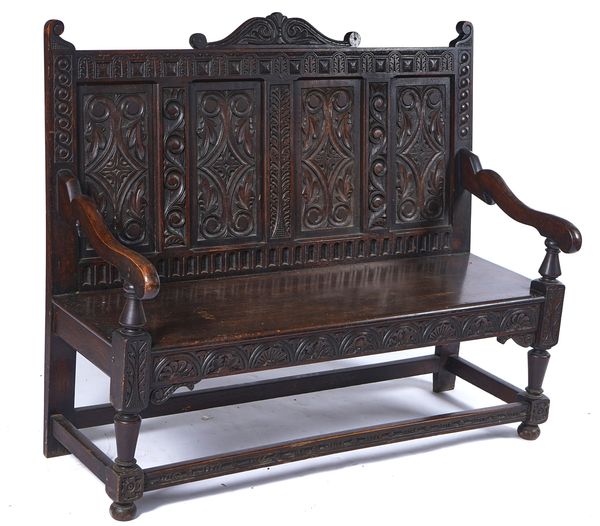 AN 18TH CENTURY STYLE CARVED OAK SETTLE