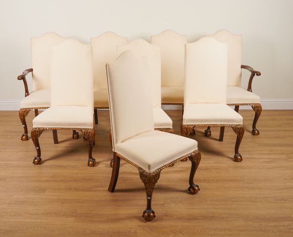 A SET OF EIGHT GEORGE I STYLE PARCEL GILT HUMP BACK DINING CHAIRS ON CLAW AND BALL FEET (8)