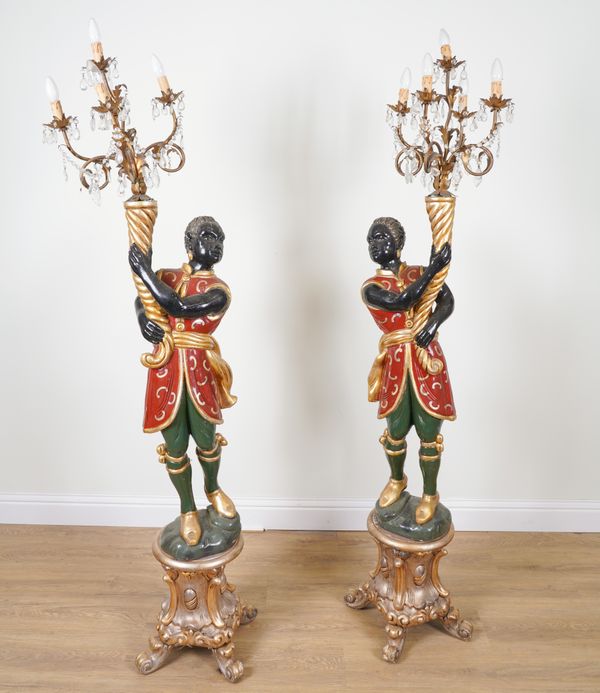 A PAIR OF POLYCHROME PAINTED MOOR FIGURAL FIVE LIGHT CANDELABRA