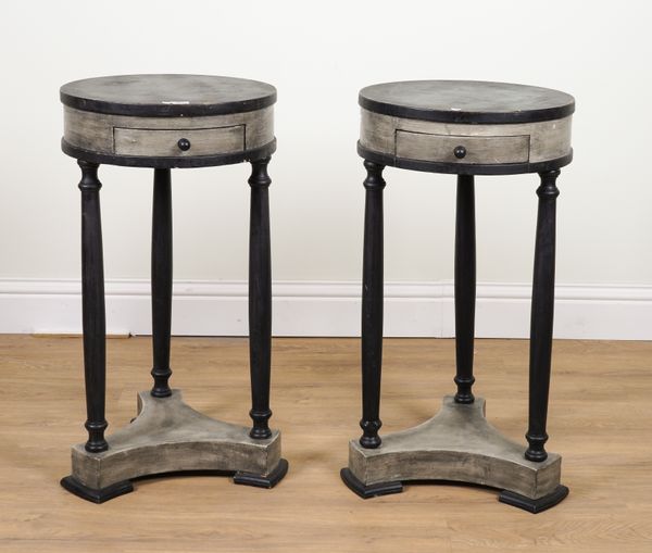 A PAIR OF EMPIRE STYLE EBONISED AND SILVER PAINTED CIRCULAR SINGLE DRAWER OCCASIONAL TABLES (2)