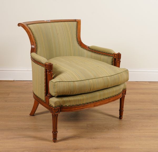 AN EARLY 20TH CENTURY FRENCH FRUITWOOD FRAMED TUB BACK EASY ARMCHAIR