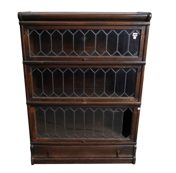 GLOBE-WERNICKE; A MID 20TH CENTURY OAK LEADED GLASS THREE SECTION BOOKCASE