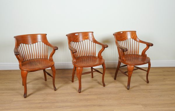 A SET OF THREE MID 20TH CENTURY OAK SPINDLE TUB BACK DESK CHAIRS (3)