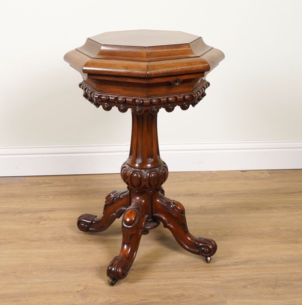 WIDGER, PLYMOUTH; AN EARLY VICTORIAN CARVED MAHOGANY OCTAGONAL TEAPOY WITH FITTED INTERIOR ON FOUR DOWNSWEPT SCROLL SUPPORTS