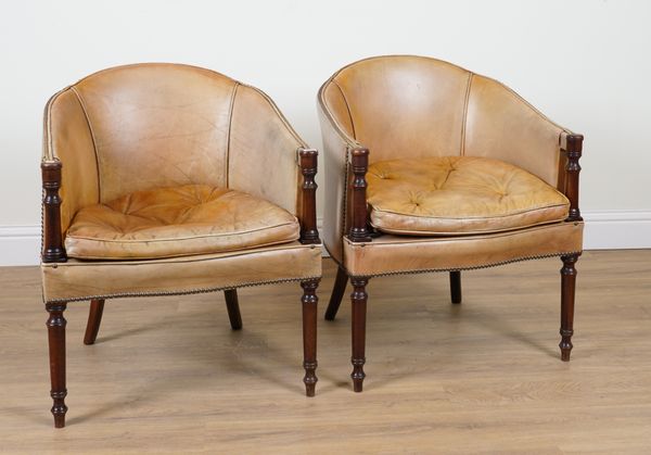 A PAIR OF REGENCY STYLE STUDDED TAN LEATHER UPHOLSTERED MAHOGANY FRAMED TUB CHAIRS (2)