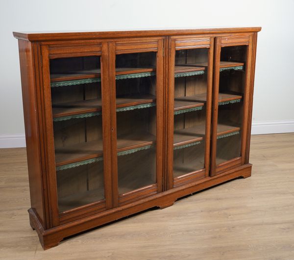 A 19TH CENTURY WALNUT FLOORSTANDING GLAZED FOUR DOOR BOOKCASE