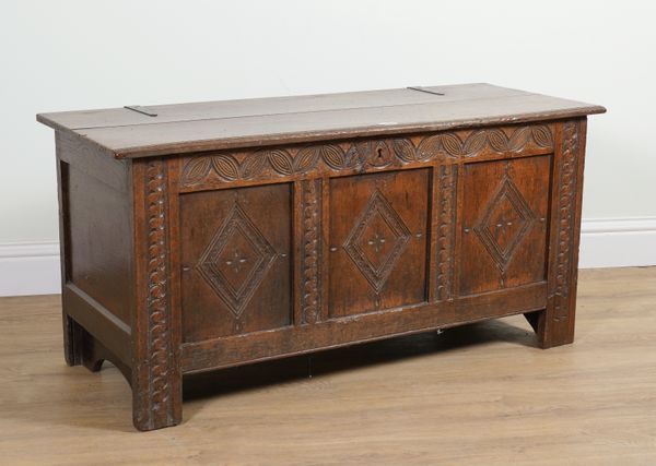 A 17TH CENTURY OAK CARVED TRIPLE PANEL COFFER