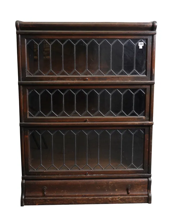 GLOBE-WERNICKE; A MID 20TH CENTURY OAK LEADED GLASS THREE SECTION BOOKCASE