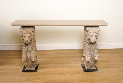 A CONSOLE TABLE WITH FAUX PAINTED RECTANGULAR MARBLE TOP ON A PAIR OF RECONSTITUTED STONE LION CARYATID SUPPORTS