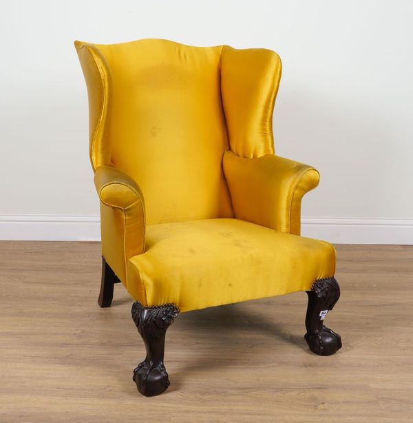 A GEORGE II STYLE MAHOGANY FRAMED WINGBACK ARMCHAIR ON HEAVY SET CLAW AND BALL FEET