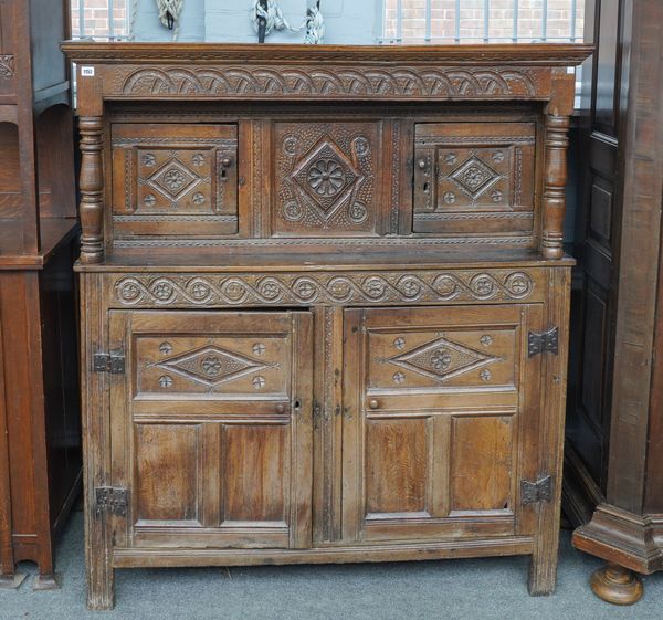 A 17TH CENTURY CARVED OAK COURT CUPBOARD