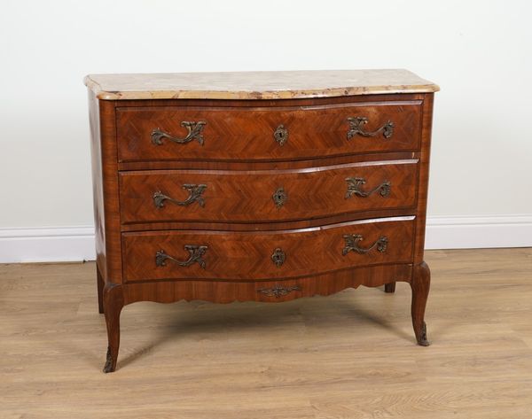 A LOUIS XV STYLE GILT METAL MOUNTED FEATHER BANDED WALNUT AND KINGWOOD SERPENTINE THREE DRAWER COMMODE