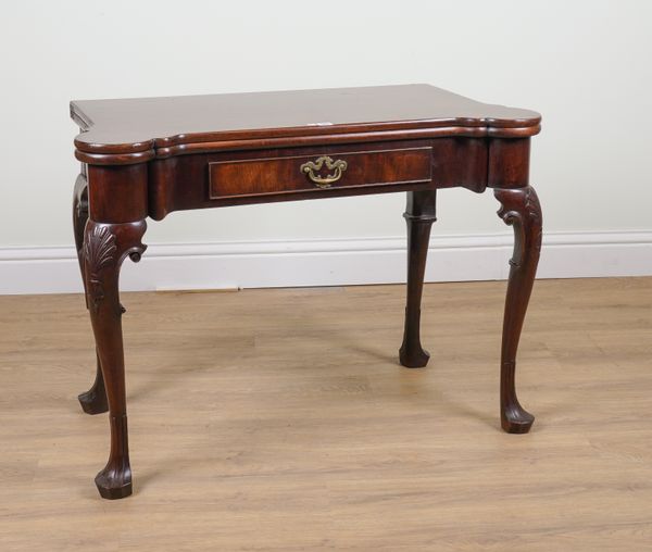 AN 18TH CENTURY MAHOGANY RECTANGULAR FOLD OVER GAMES TABLE WITH OUTSTEPPED ROUNDER CORNERS ON SHELL CAPPED PAD FEET