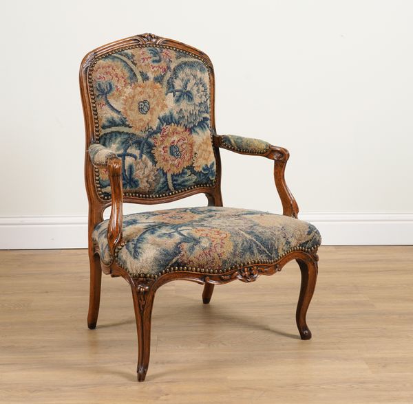 A LOUIS XV WALNUT FRAMED OPEN ARMCHAIR WITH GROS POINT NEEDLEWORK UPHOLSTERY