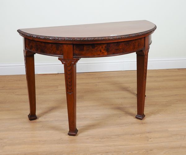 A VICTORIAN MAHOGANY AND BURR WALNUT DEMI-LUNE CONSOLE TABLE ON CARVED TAPERING SQUARE SUPPORTS