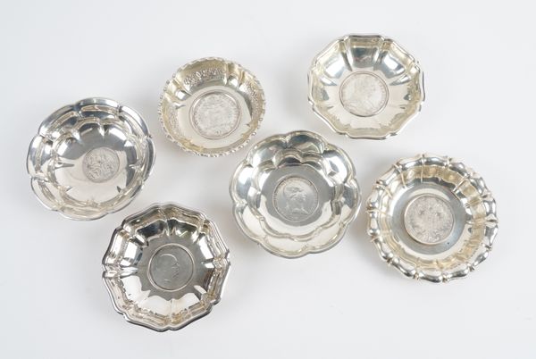 SIX FOREIGN AND PLATED DISHES MOUNTED WITH COINS (6)