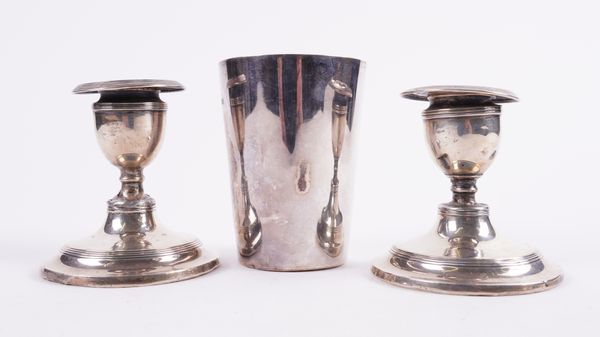 A LATE VICTORIAN SILVER CHRISTENING BEAKER AND A PAIR OF SILVER CANDLESTICKS (2)