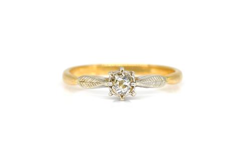 A GOLD AND PLATINUM DIAMOND SINGLE STONE RING