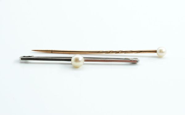 A WHITE GOLD AND CULTURED PEARL BAR BROOCH AND A CULTURED PEARL STICK PIN (2)