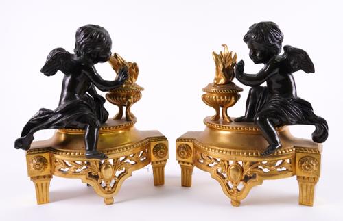 A PAIR OF LOUIS XVI STYLE BRONZE MOUNTED GILT-METAL CHENETS (2)