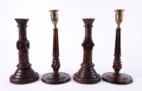 A PAIR OF VICTORIAN GOTHIC REVIVAL OAK CANDLESTICKS (4)