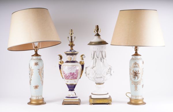 A LARGE GIlT-METAL MOUNTED BISCUIT PORCELAIN TABLE LAMP (4)