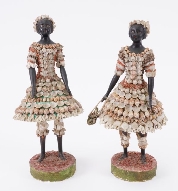 MARITIME FOLK ART: TWO SHELL ENCRUSTED FIGURES OF LADIES IN CONICAL SKIRTS AND KNICKERBOCKERS (2)