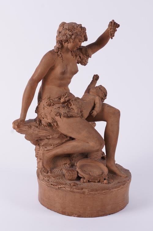IN THE MANNER AFTER JOSEPH CHARLES MARIN (FRENCH 1759-1834): A TERRACOTTA GROUP DEPICTING A BACCHANTE FEEDING A FAUN